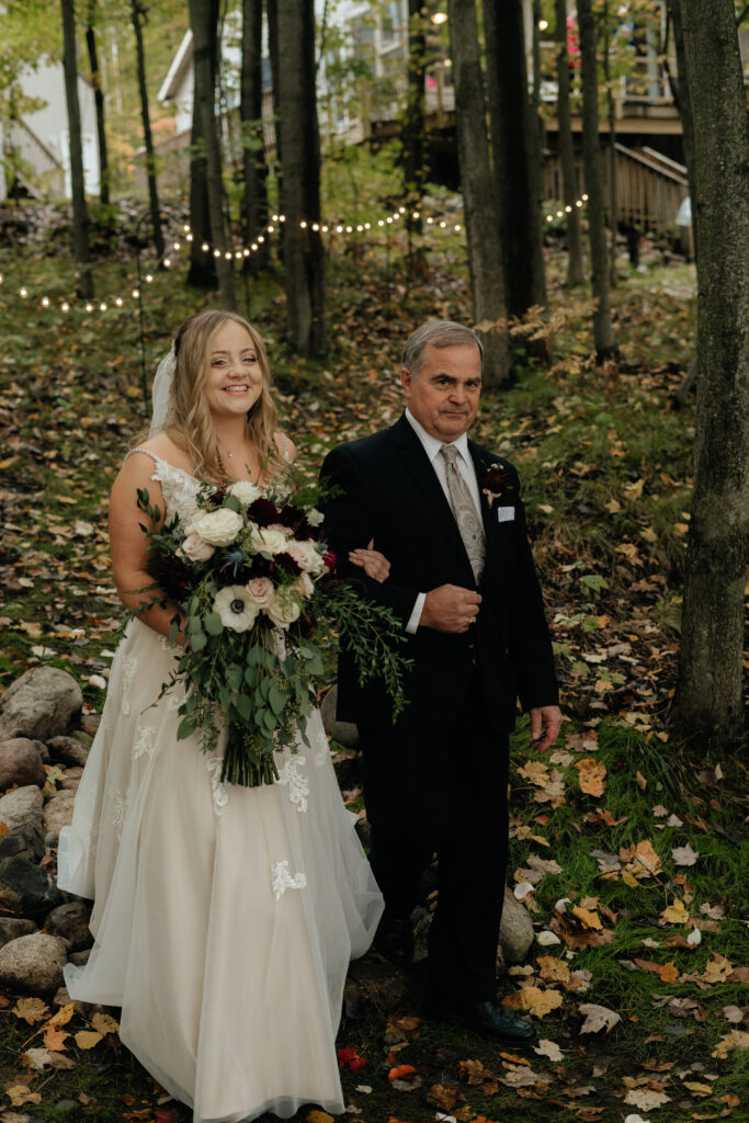 The bride and her father walk down the aisle towards the altar at her elopement. 