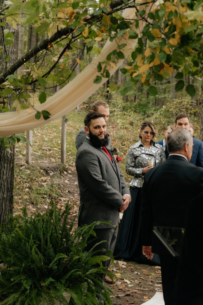 The groom's first look at the bride as she walks down the aisle at their elopement in Northern Michigan.