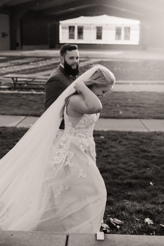 A couple that's eloped walks down to the lakeside