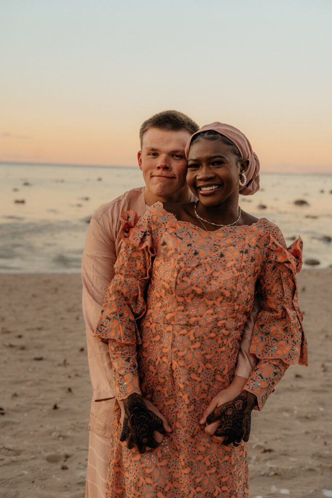 A couple embraces on Mission Point beach