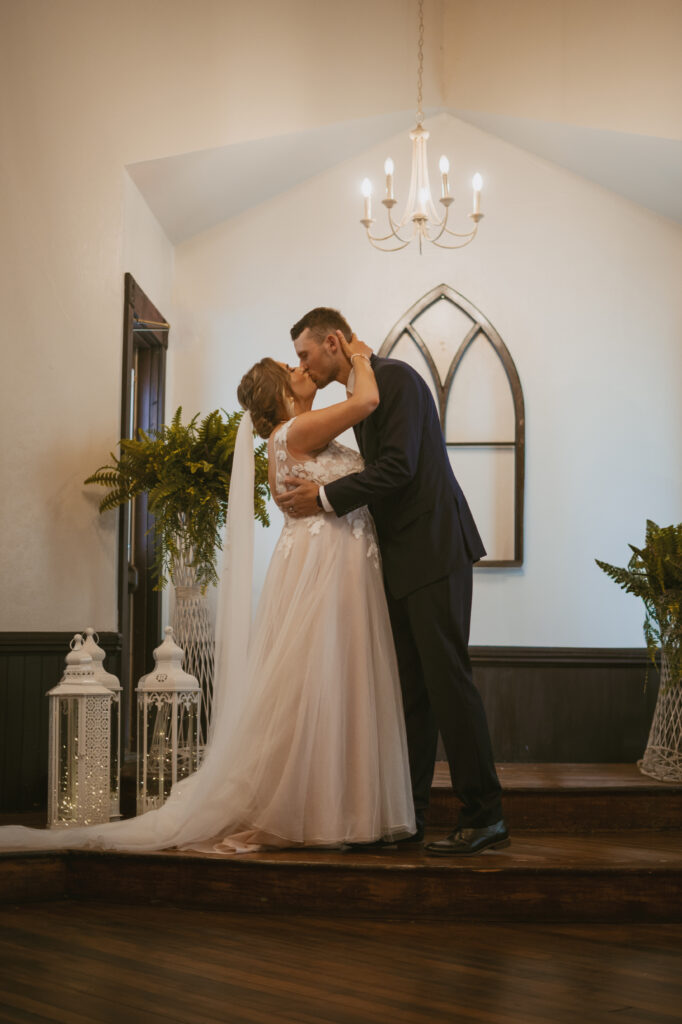 A couple shares their first kiss at the front of the chapel for their intimate micro wedding in Michigan. 