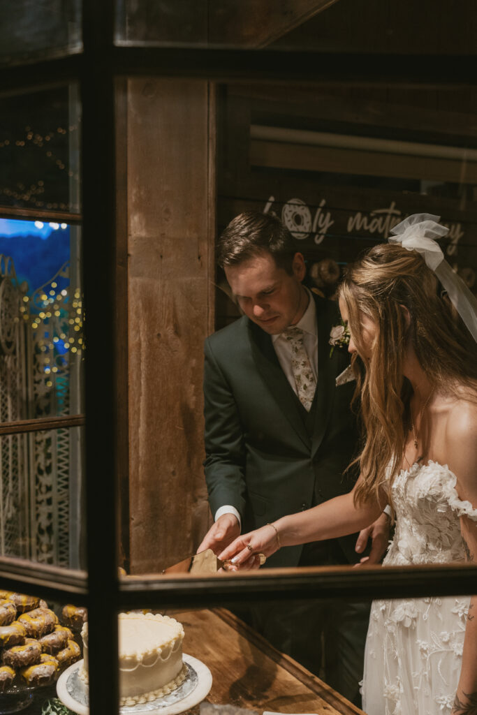 bride and groom cut cake