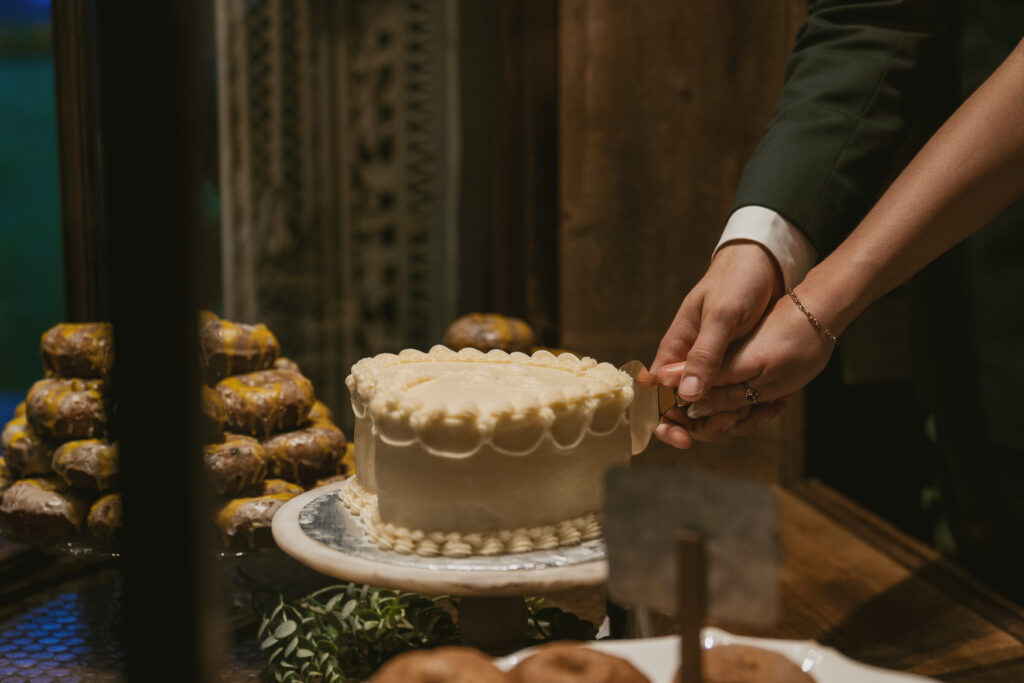 bride and groom cut cake