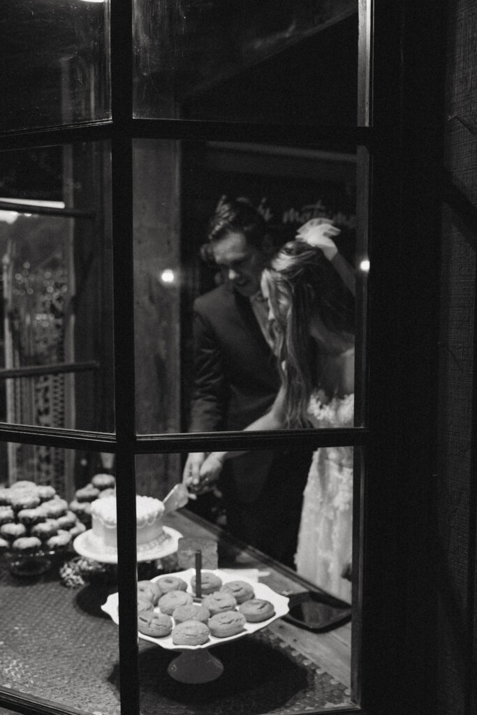 bride and groom cut cake