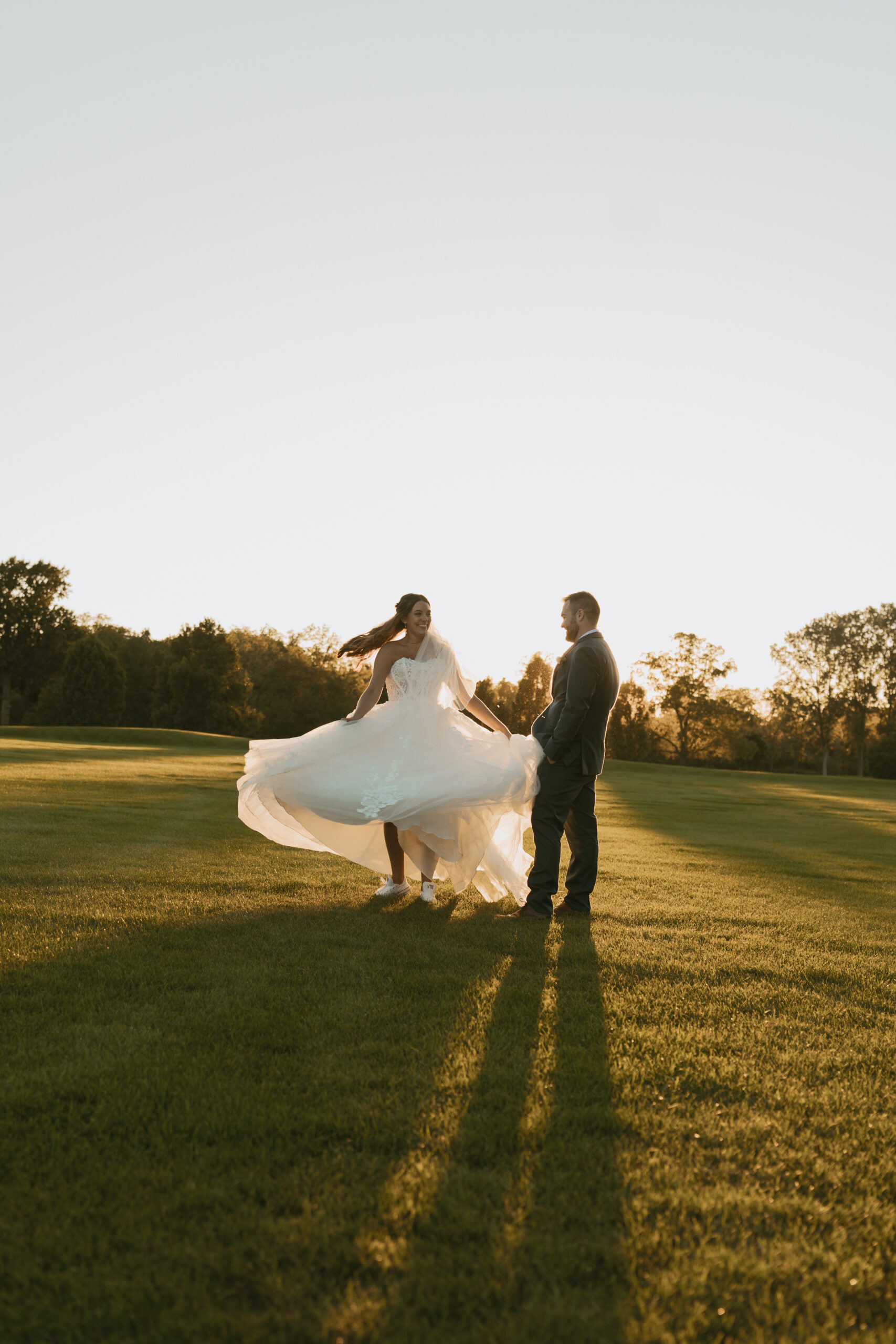 Couple Twirls in the golden hour light after their elopement in Michigan