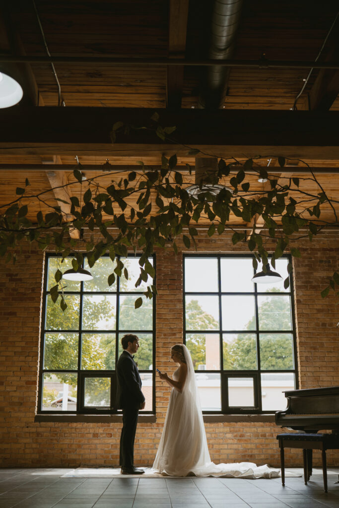 Bride and Groom exchange vows underneath ivy