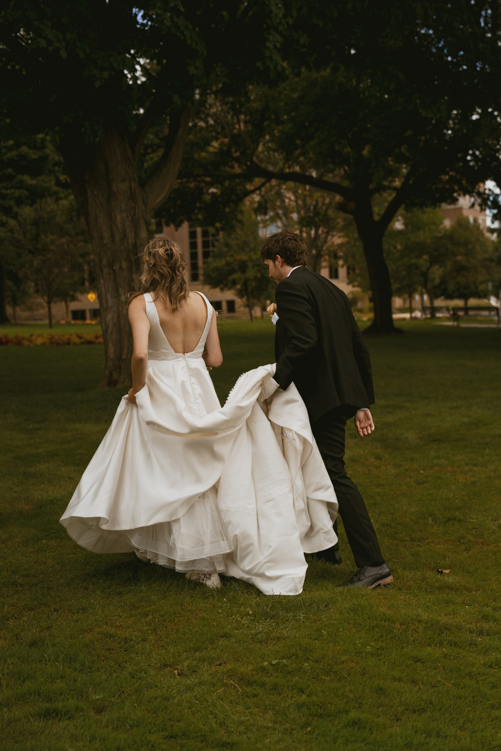 Bride and groom wandering through park in Downtown Grand Haven Michigan