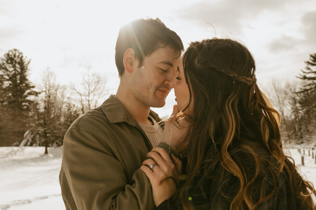 engaged couple embraces in the wintery wonderland