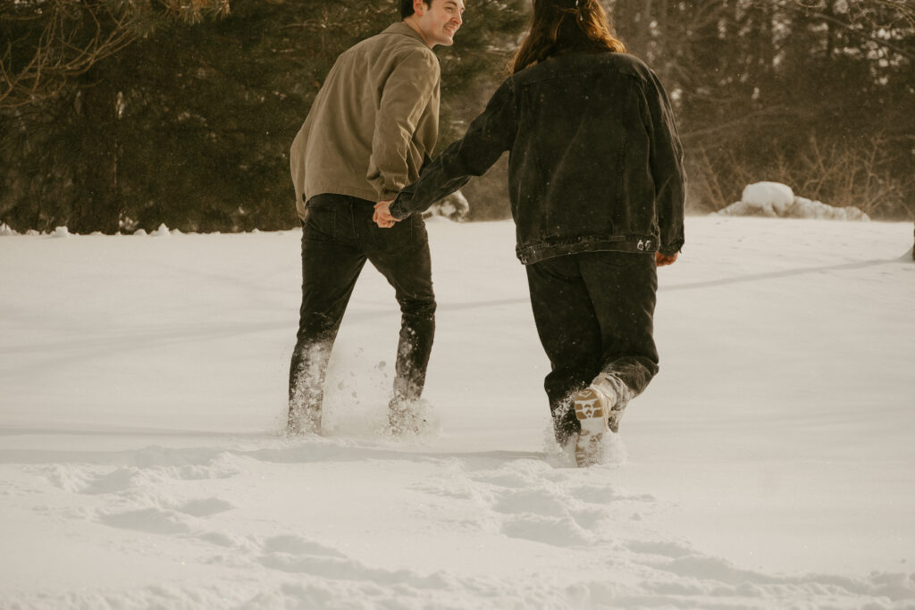 Couple walks through the snow 