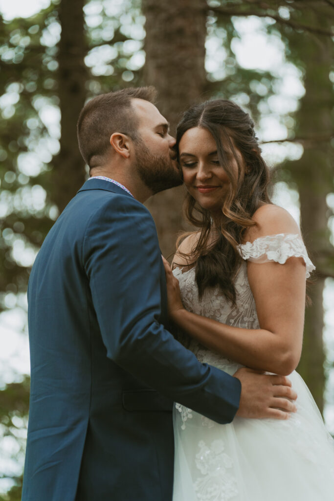 Newlyweds share a private moment in the woods