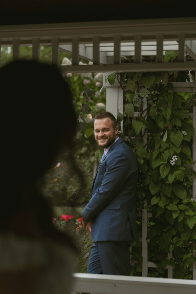 A Groom admires his bride in a documentary style photograph