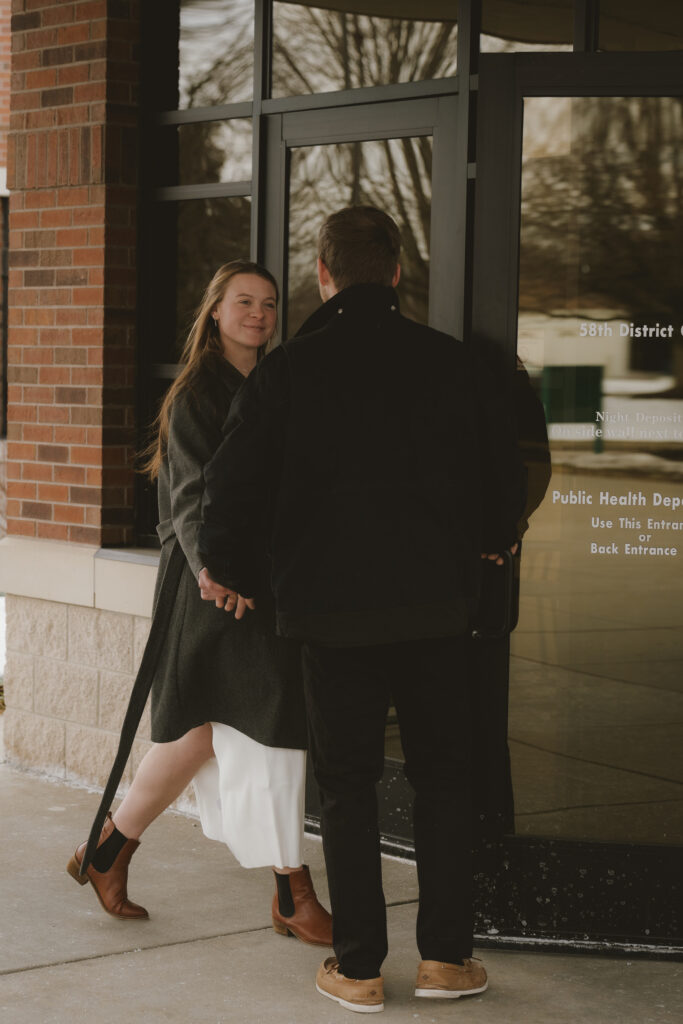 Couple embraces outside of the courthouse