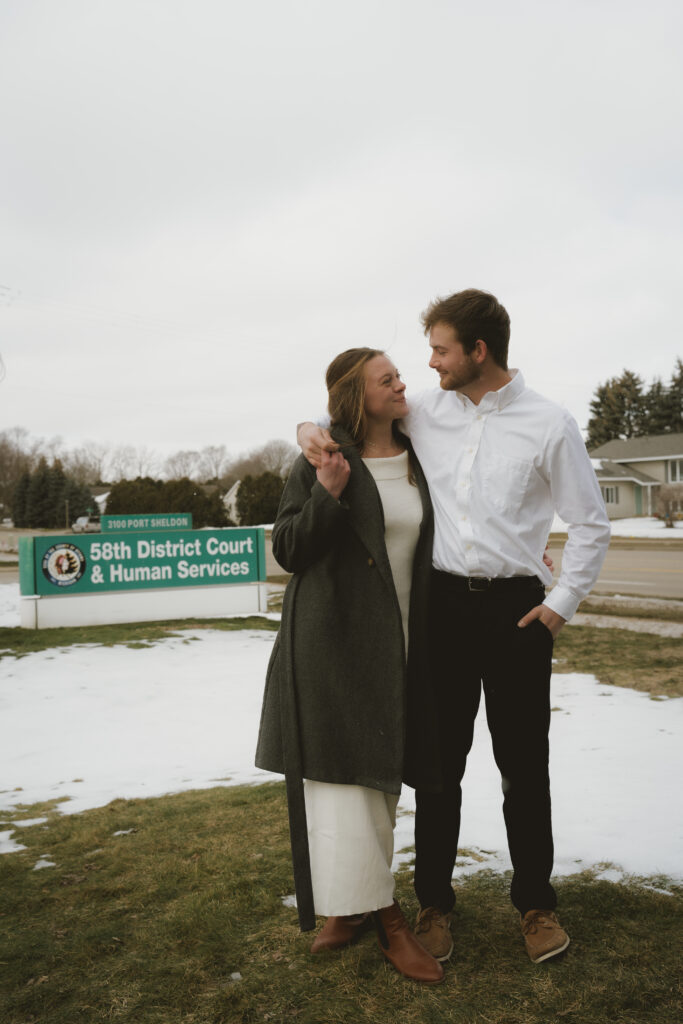 Couple embraces outside of the courthouse