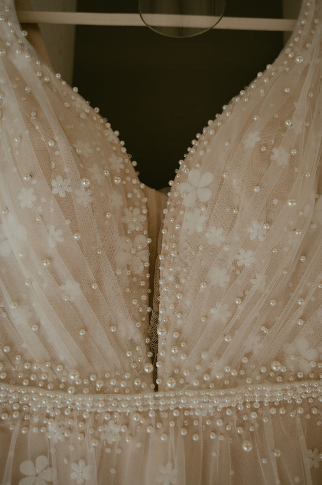 brides wedding dress hangs as she prepares for her stunning wedding day