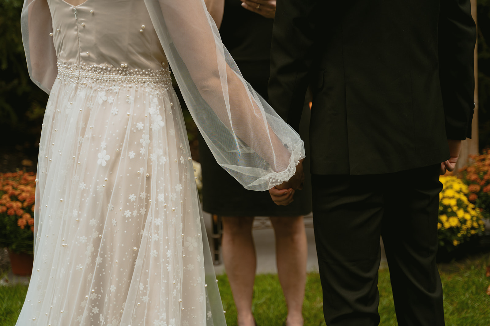 bride and groom hold hands as their micro wedding begins