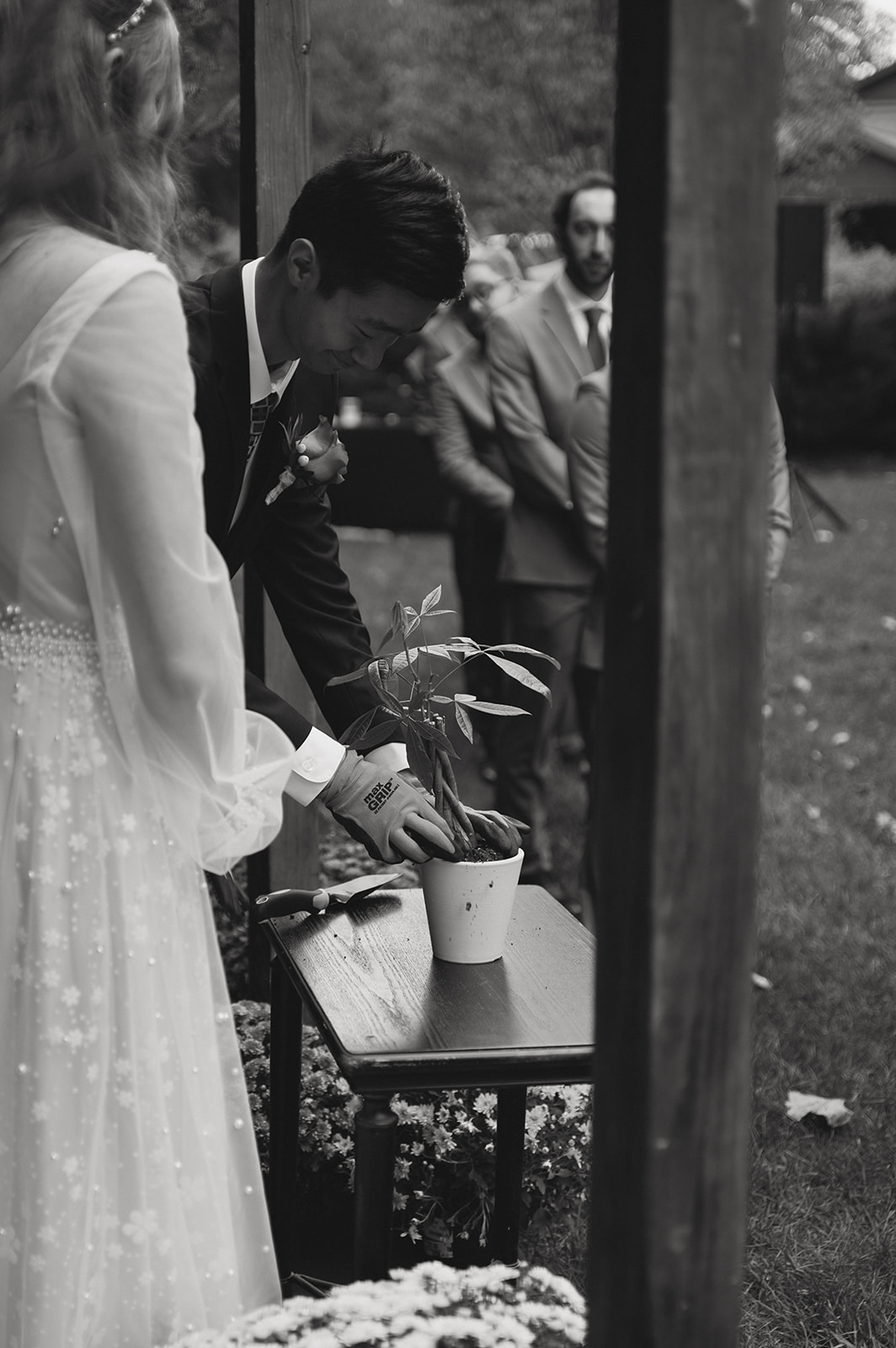 bride and groom pot a plant together to celebrate their new marriage!