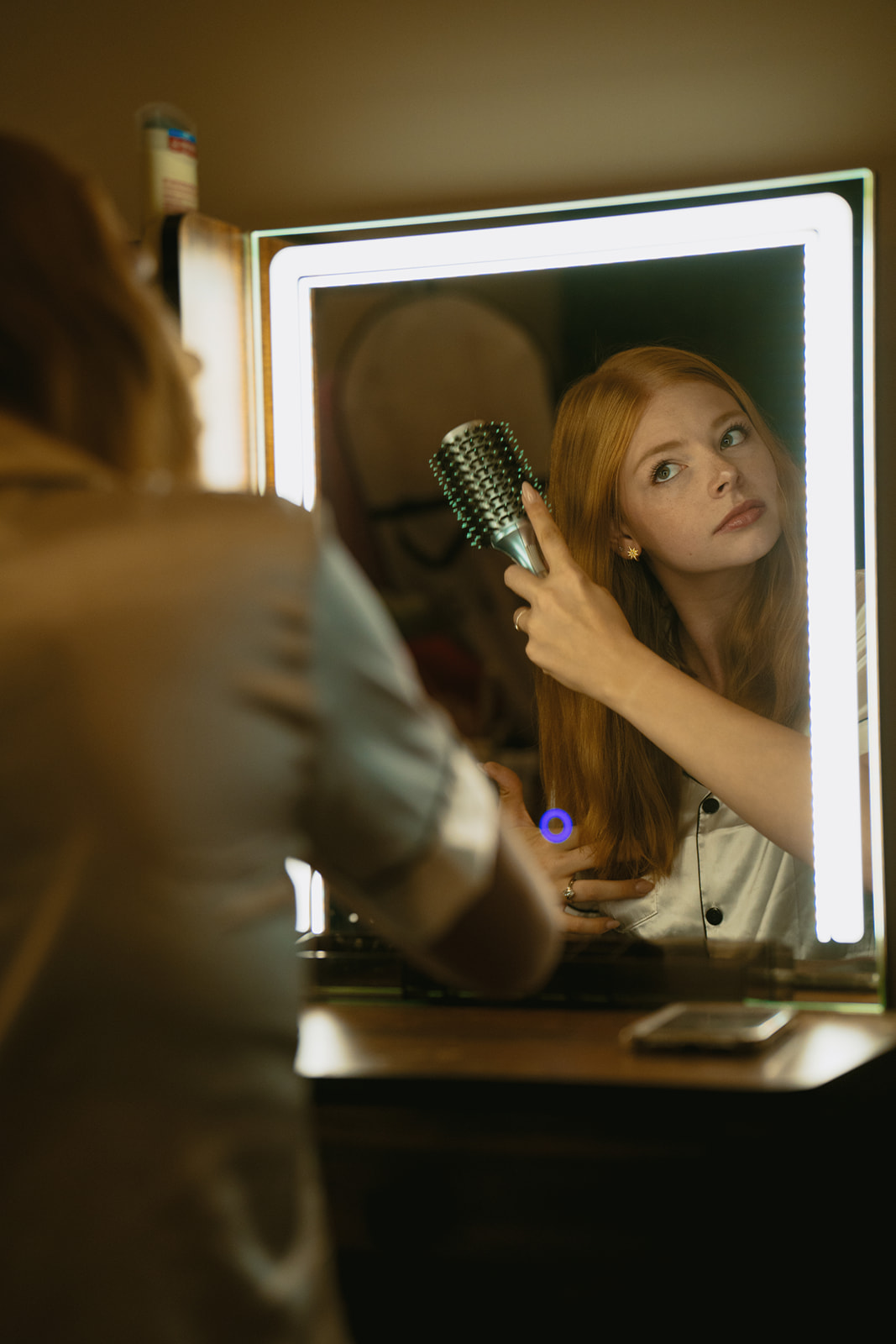bride preps her hair before her beautiful micro wedding