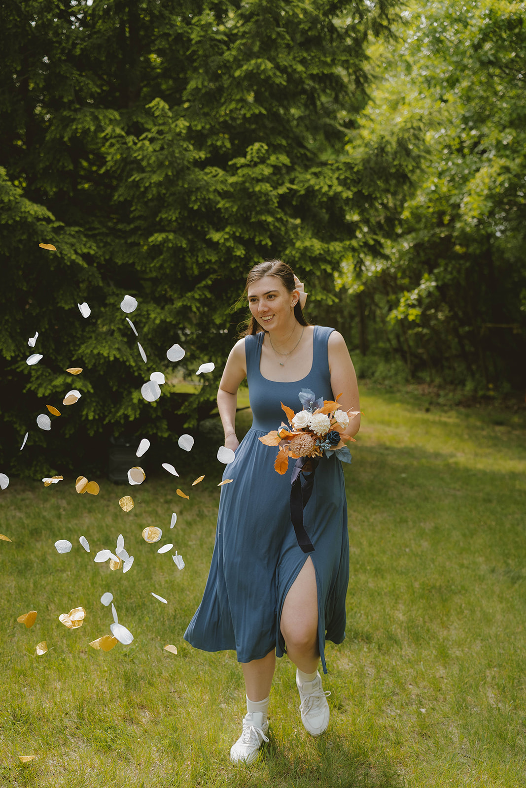 flower girl enters the stunning backyard wedding ceremony