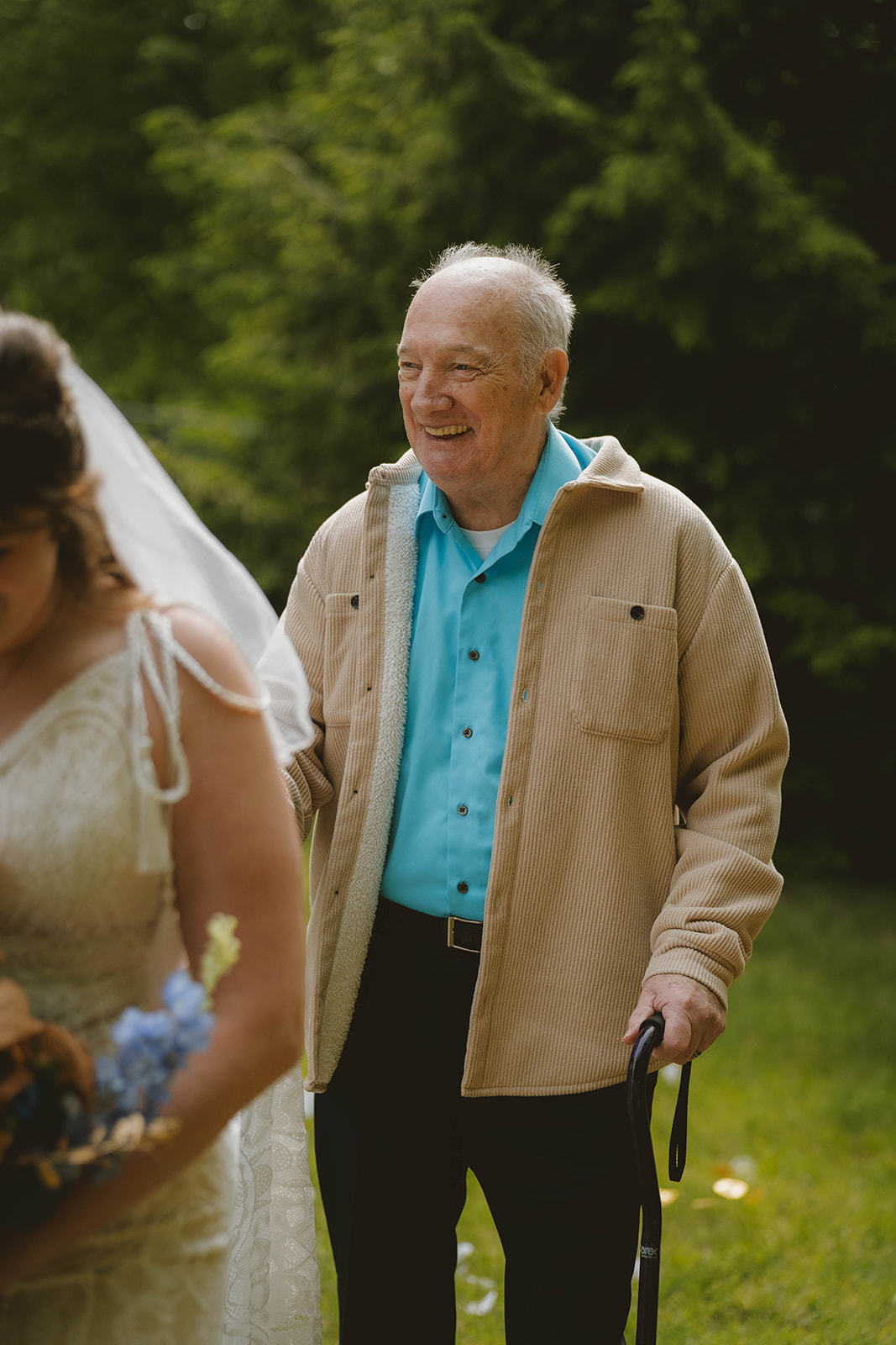 bride and her grandpa enter the stunning wedding ceremony in the backyard