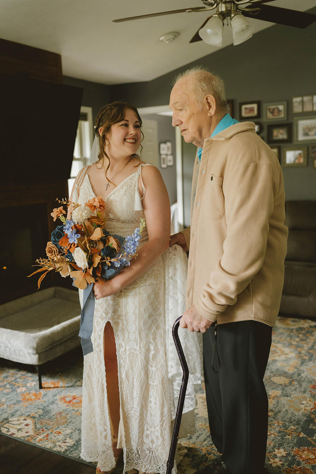 bride and her grandpa pose froa photo together before her backyard wedding