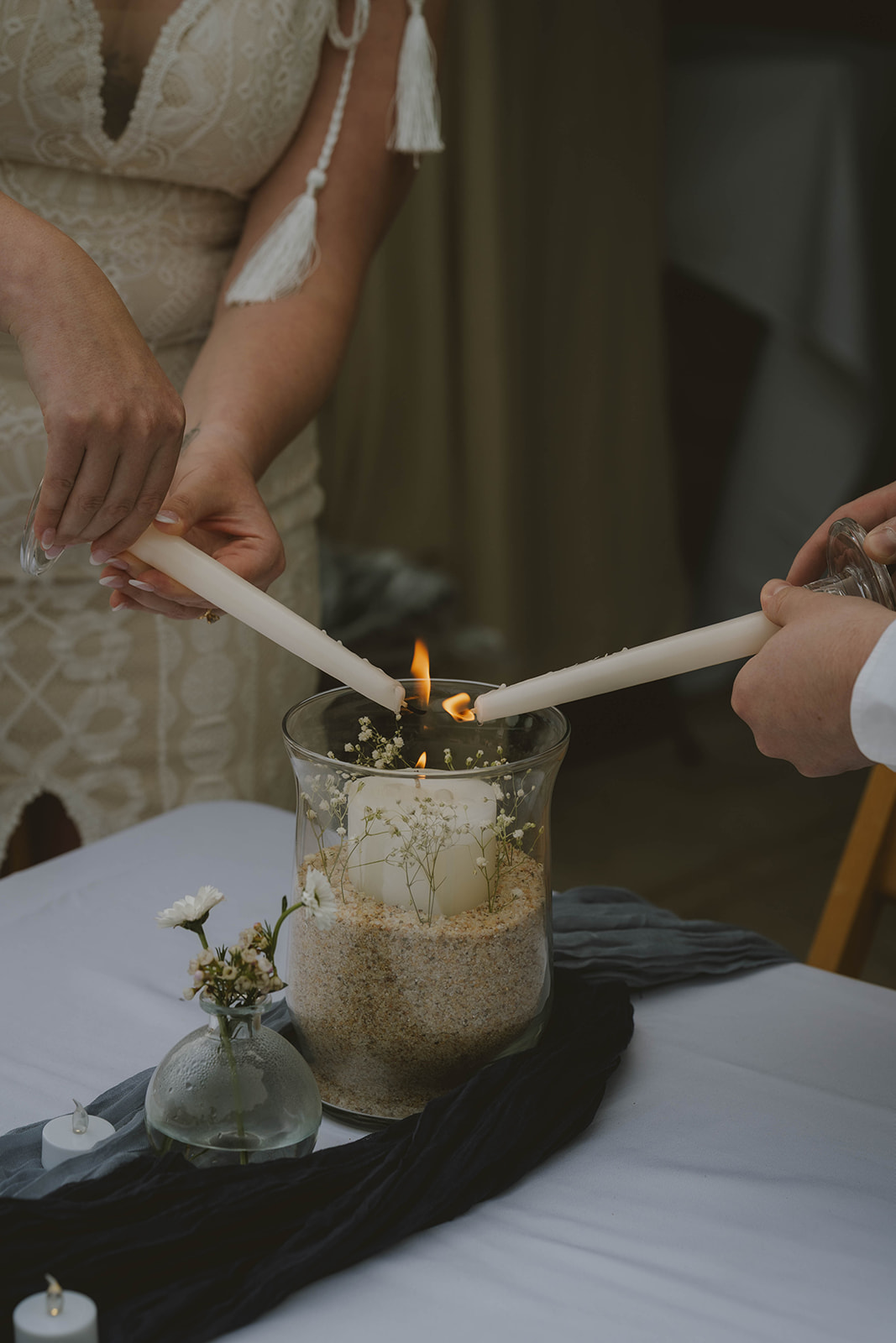 bride and groom light a candle together