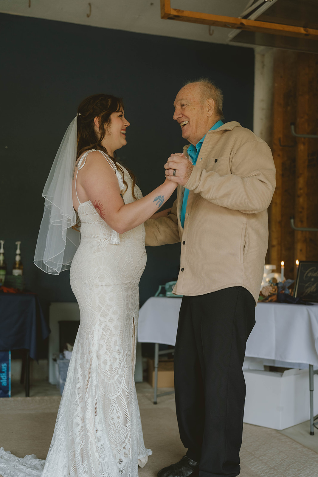 bride and her grandpa share a dance together after the backyard wedding ceremony