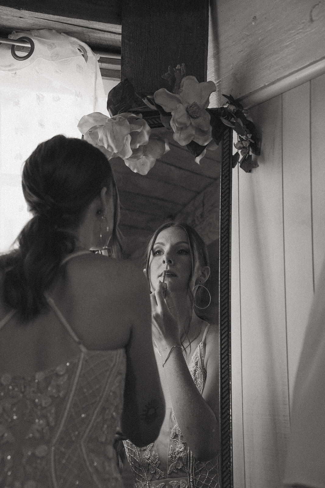 bride adds final touches as she finishes getting ready for her elopement ceremony