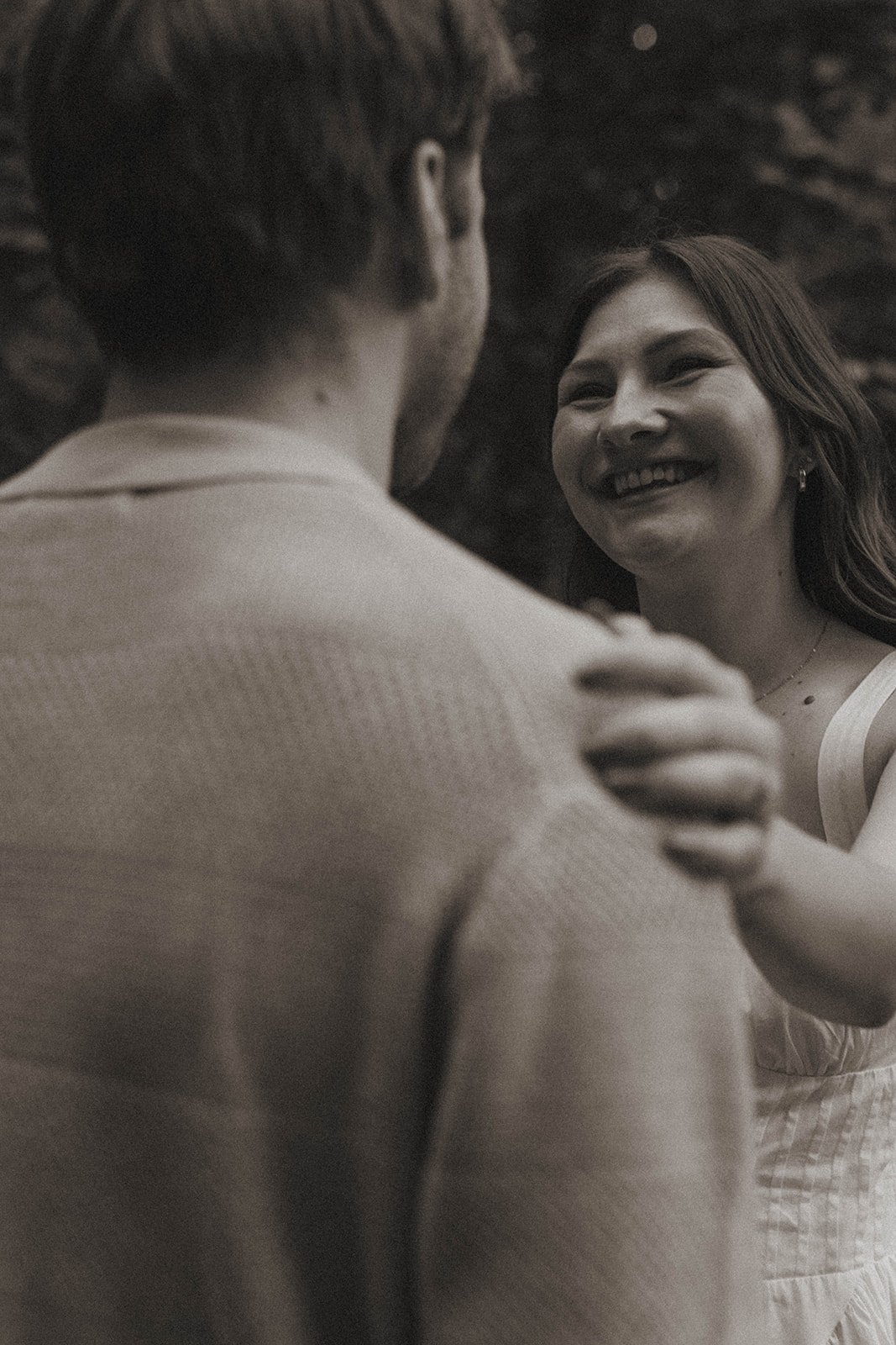 stunning couple dance in the park and take candid photos during their Grand Rapids engagement photo session