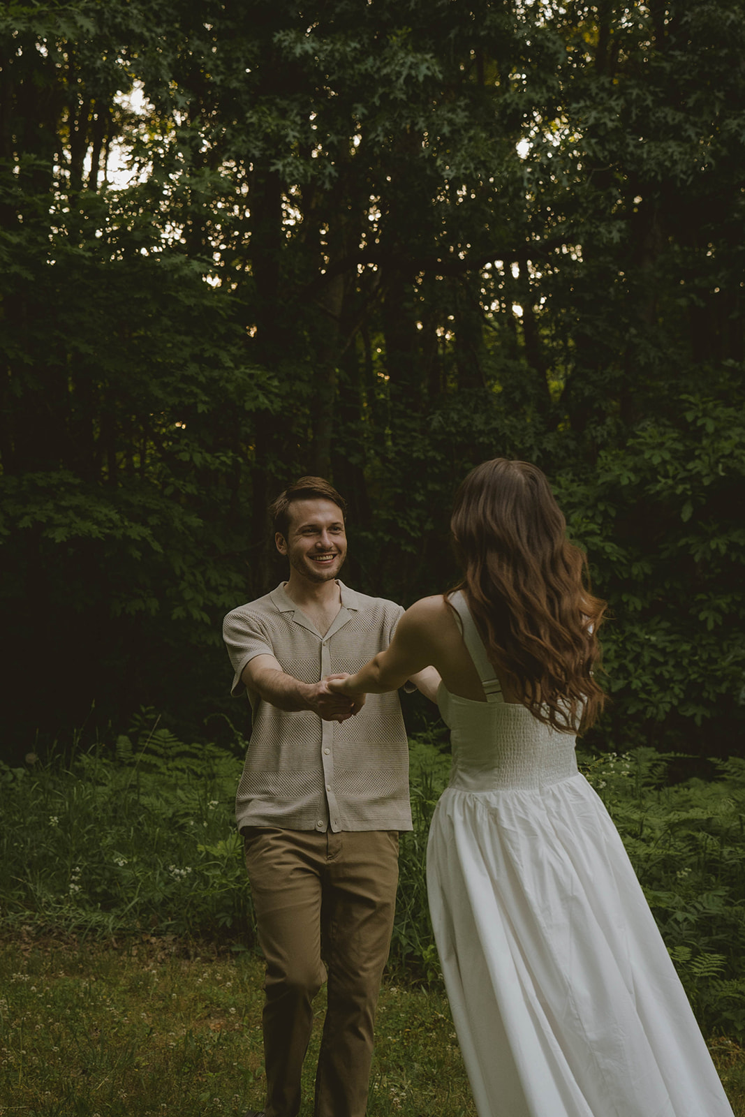 stunning couple dance in the park and take candid photos during their Grand Rapids engagement photo session