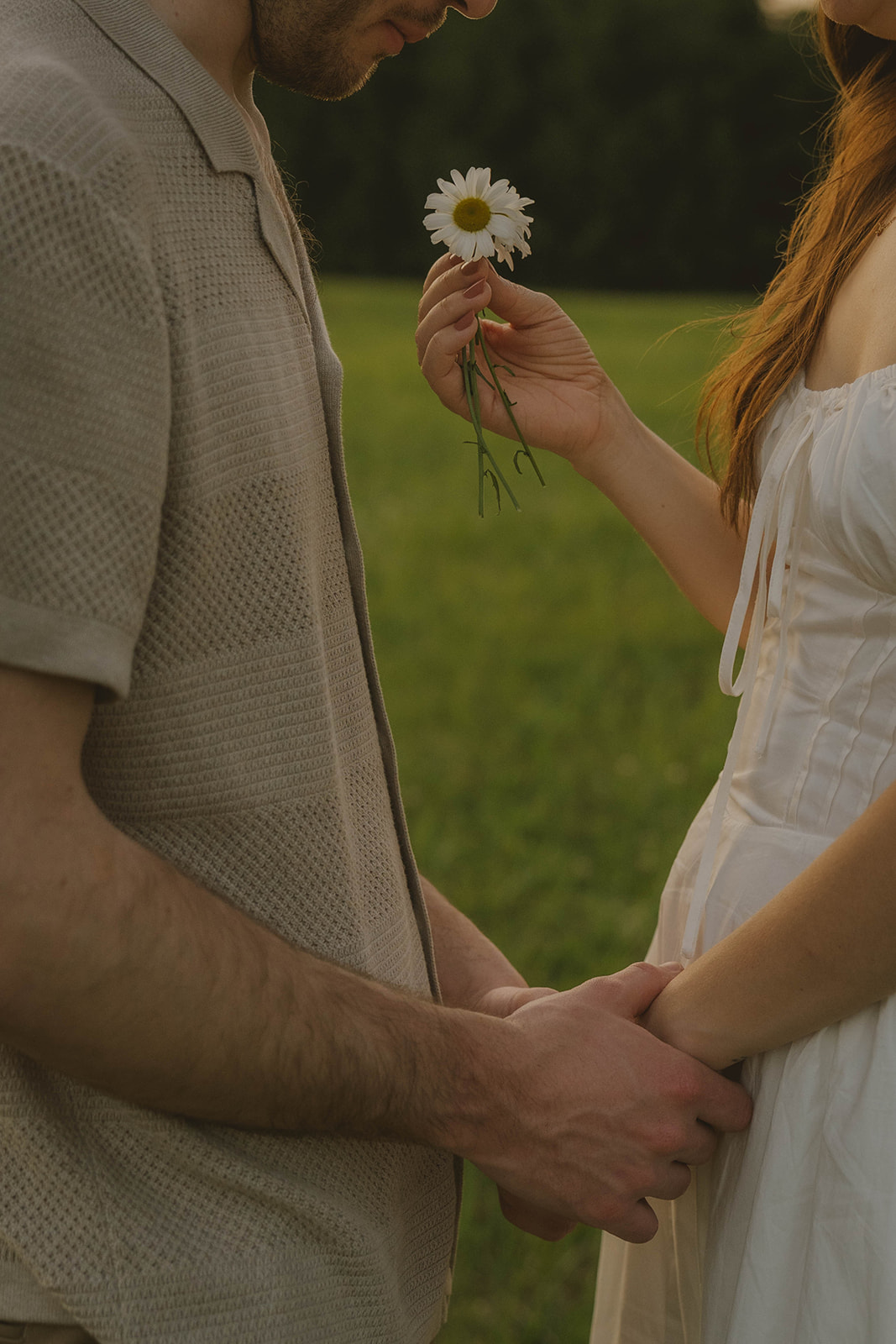 stunning couple share an intimate moment and wildflower together