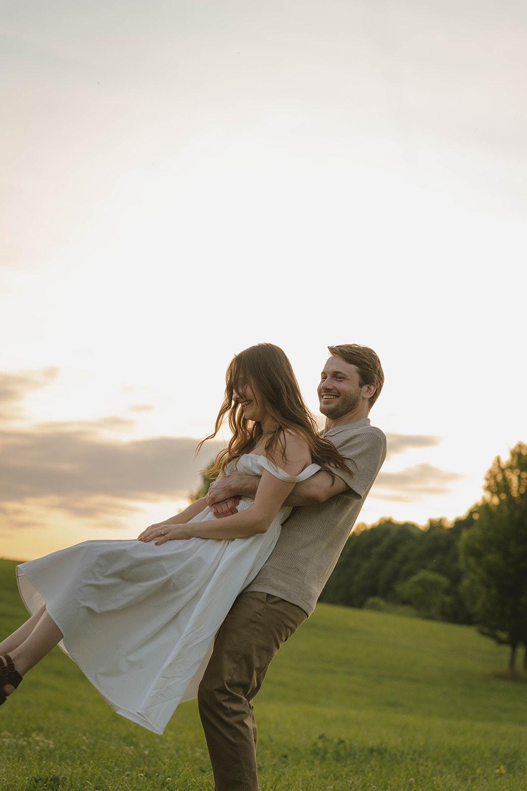 couple take intimate moments together during golden hour in the stunning Michigan field