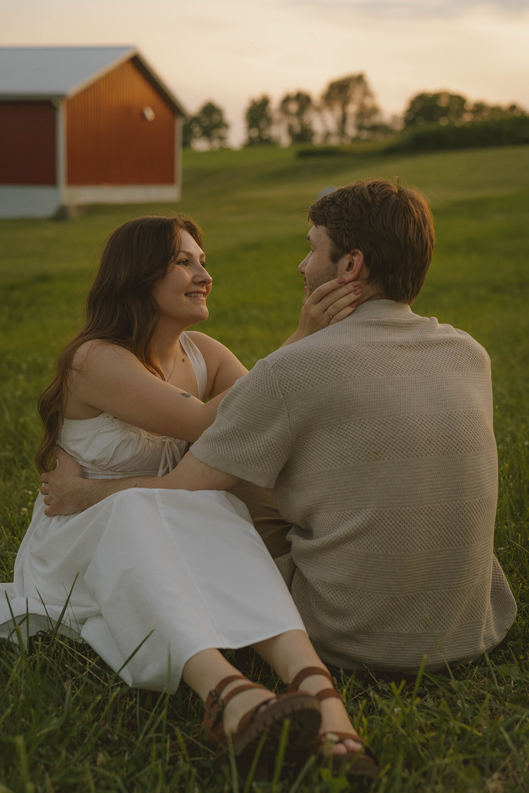 couple take intimate moments together during golden hour in the stunning Michigan field