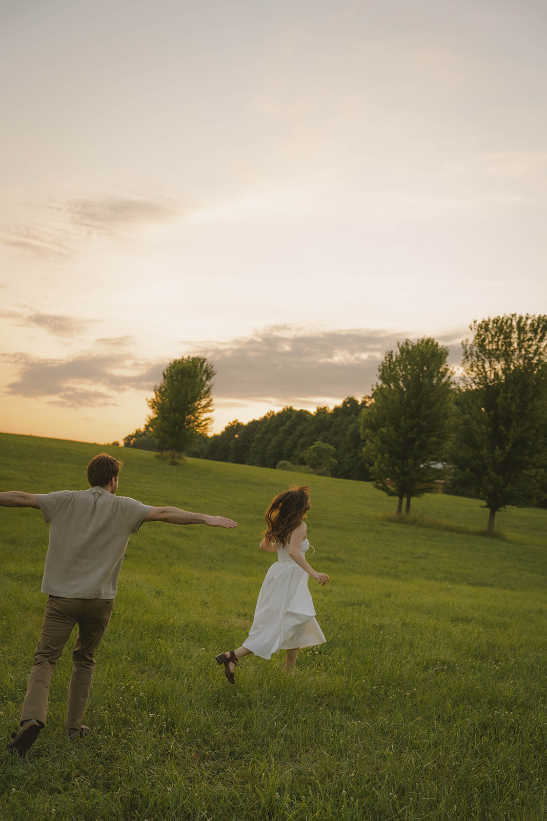 couple share playful moments during a their Grand Rapids engagement photoshoot