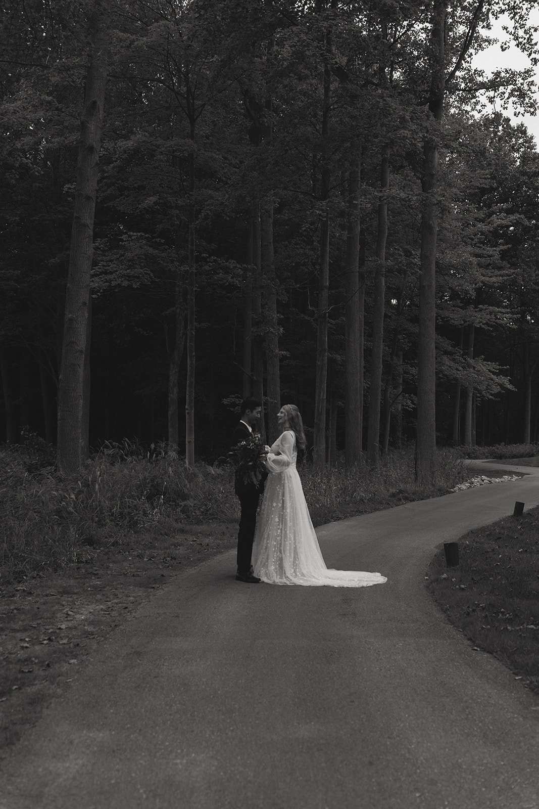 stunning bride and groom pose in the forest together during their fall wedding!