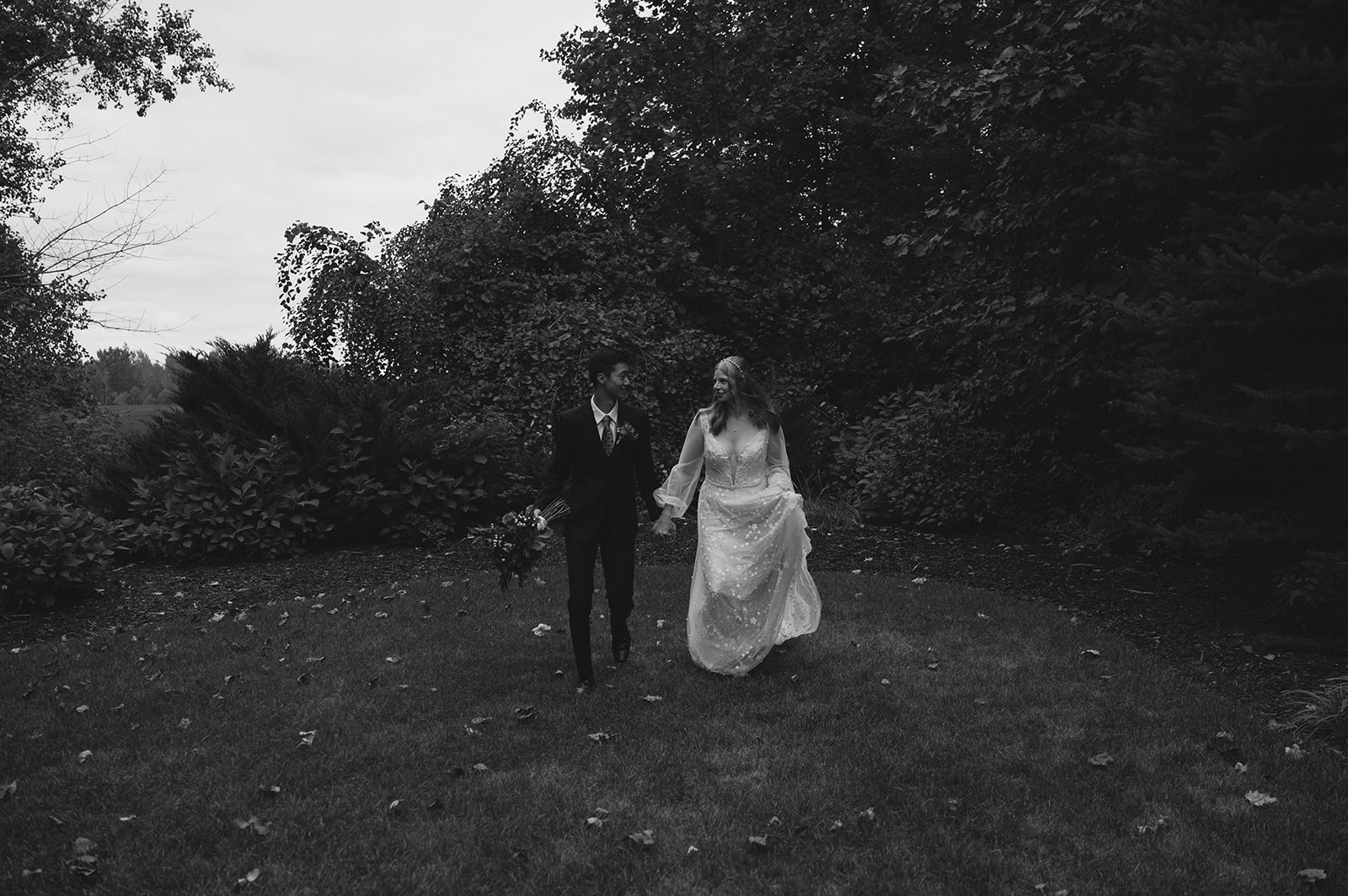 bride and groom hold hands and share an intimate moment during their winter elopement in Michigan 