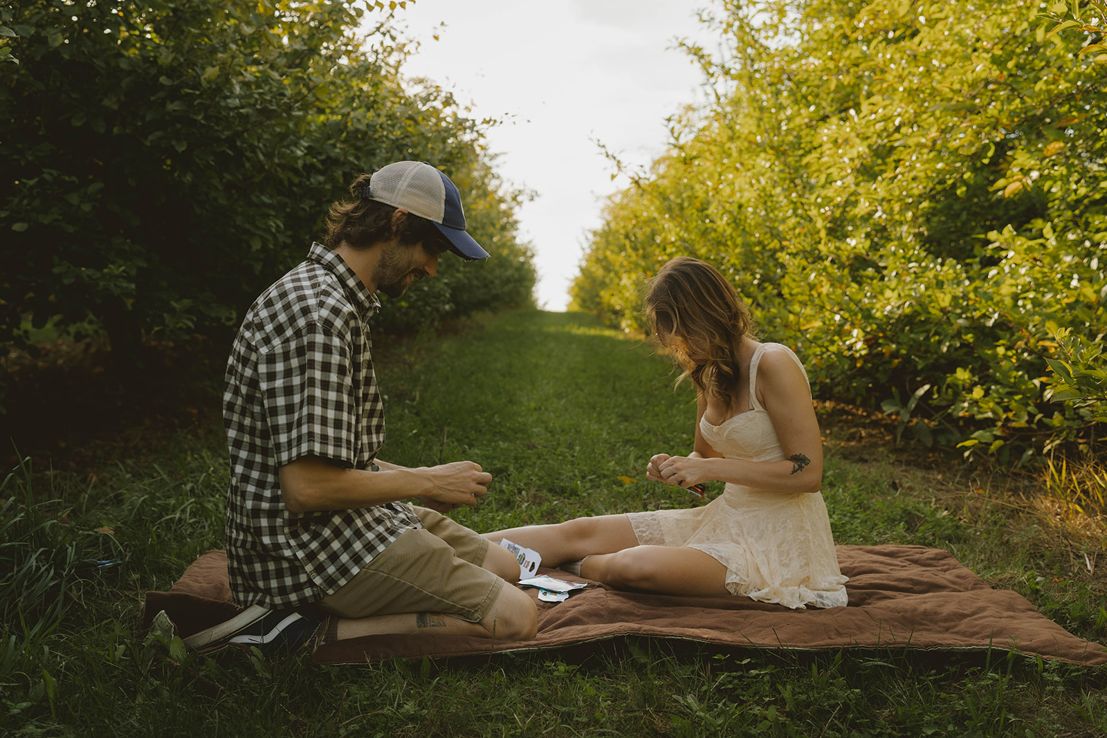 couple open pokemon cards during their fun engagement photoshoot