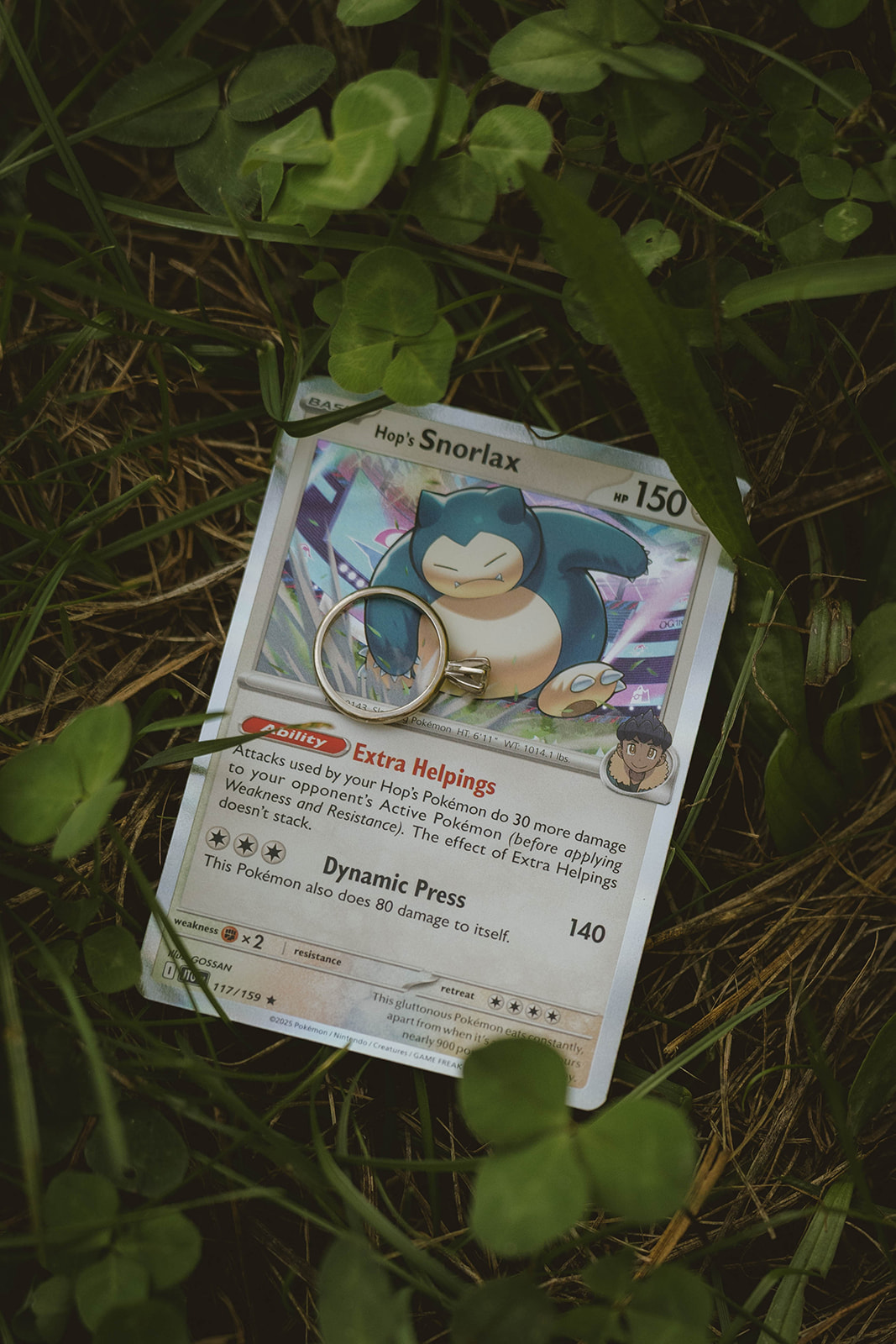 engagement ring lays on a pokemon card