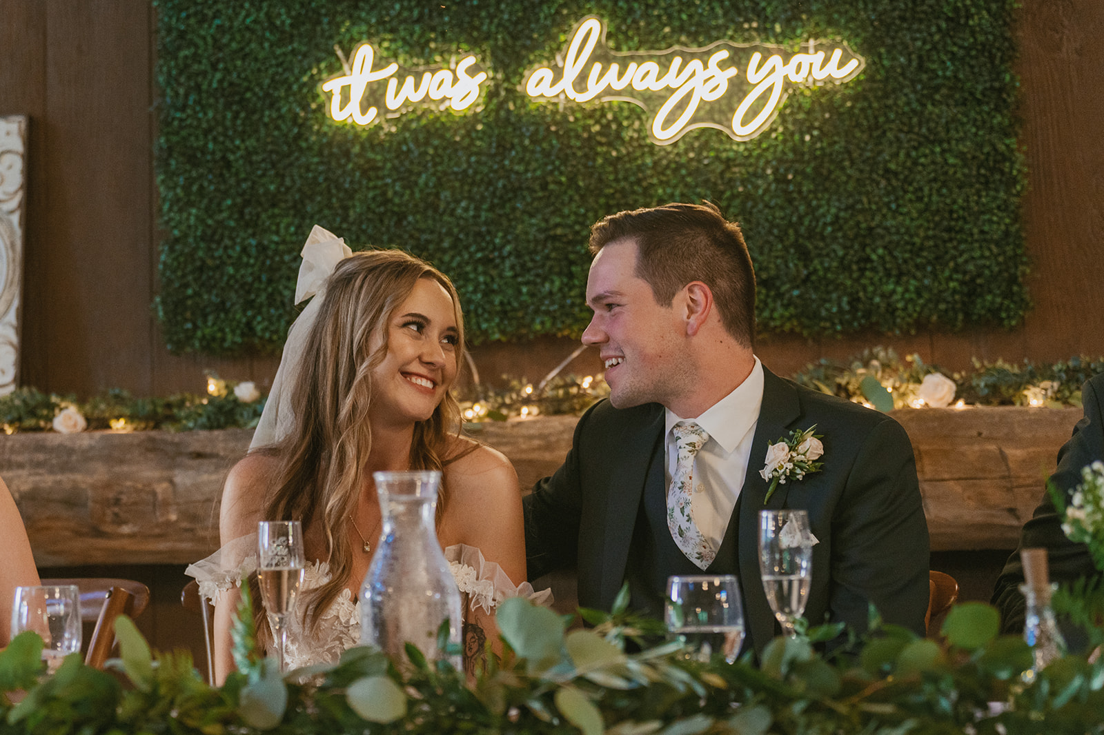bride and groom share a laugh during their wedding reception