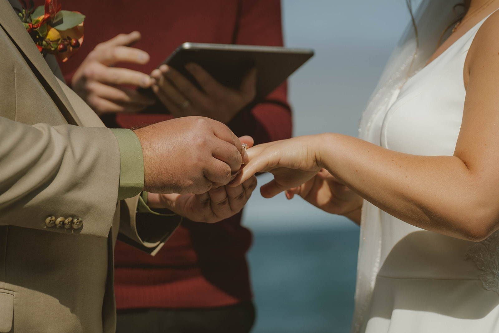 groom slides the ring on his brides finger