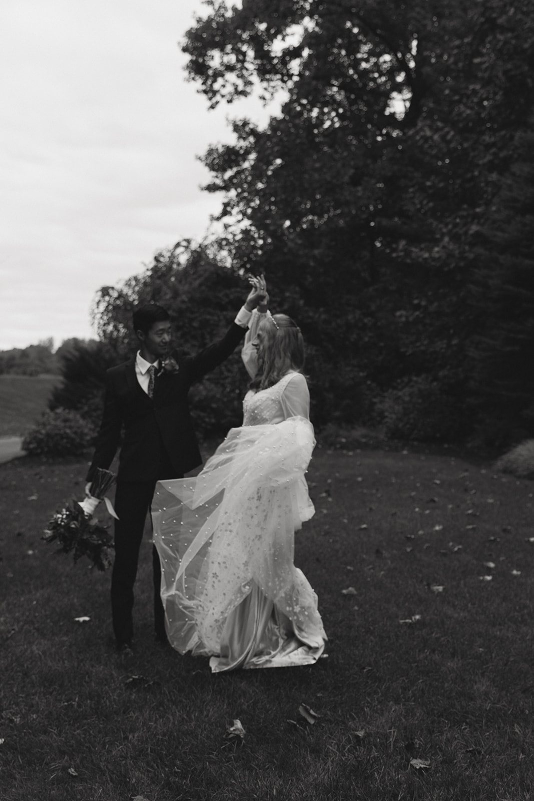 documentary style wedding photo of a bride and groom dancing