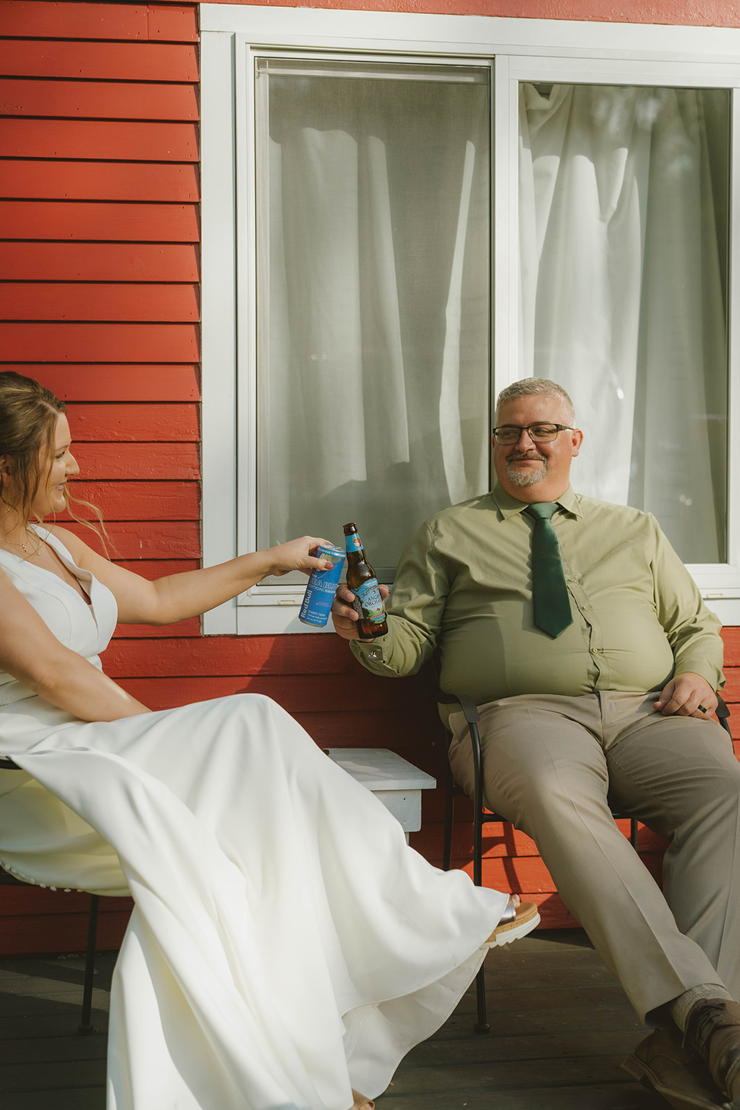 bride and groom share a beer after a long wedding day