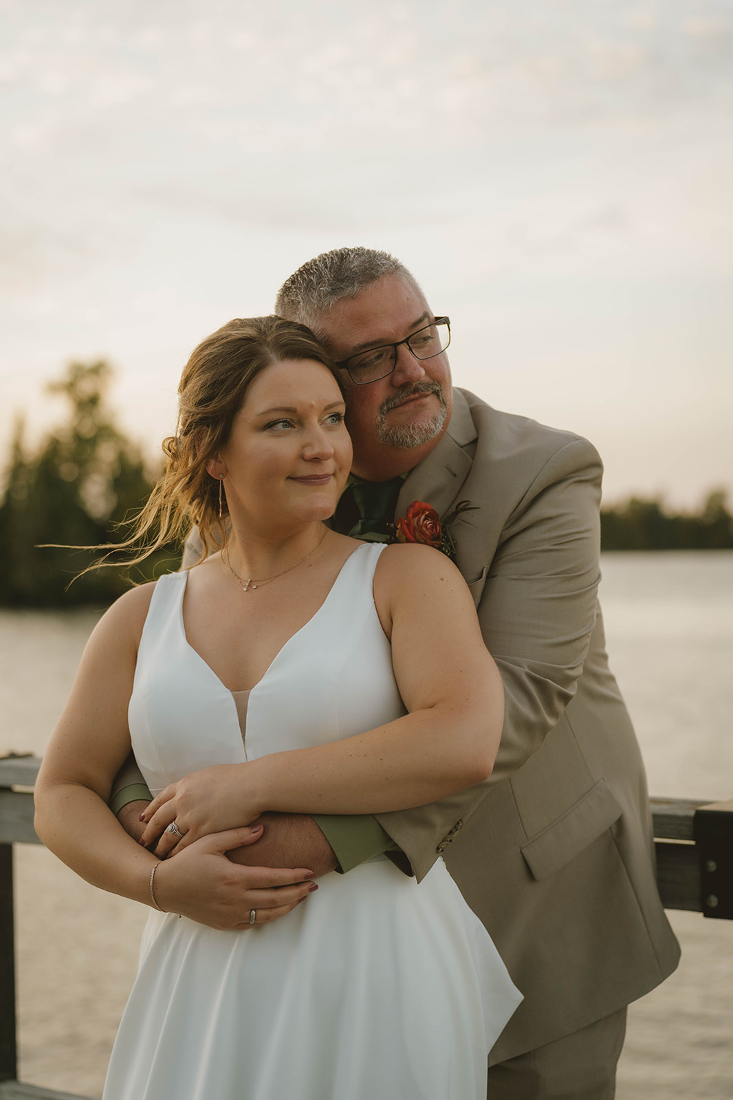 bride and groom share a hug by Copper Harbor