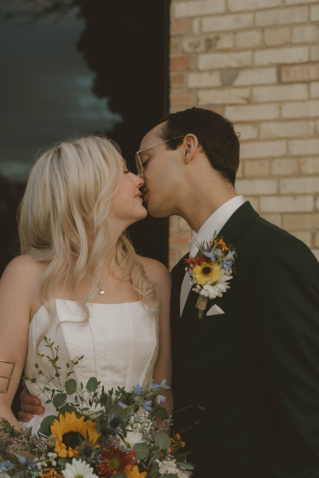 bride and groom share a kiss after their winter wedding in Michigan