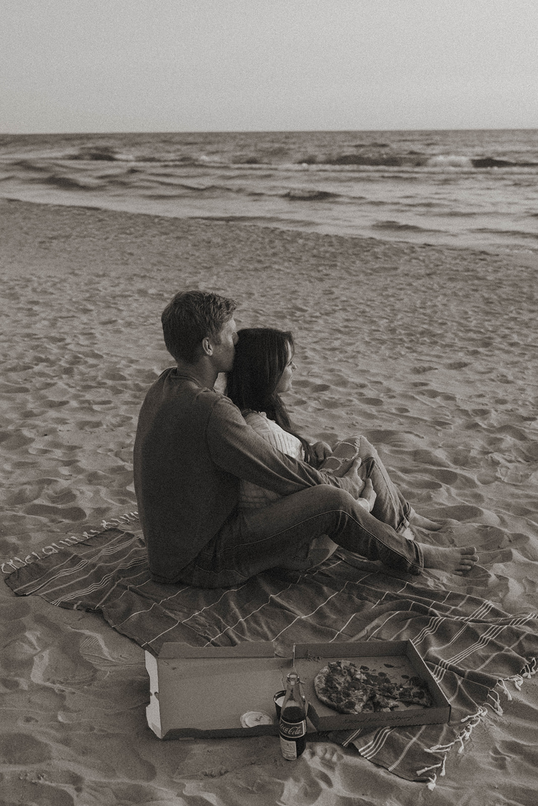couple embrace and look out at the Lake Michigan waves