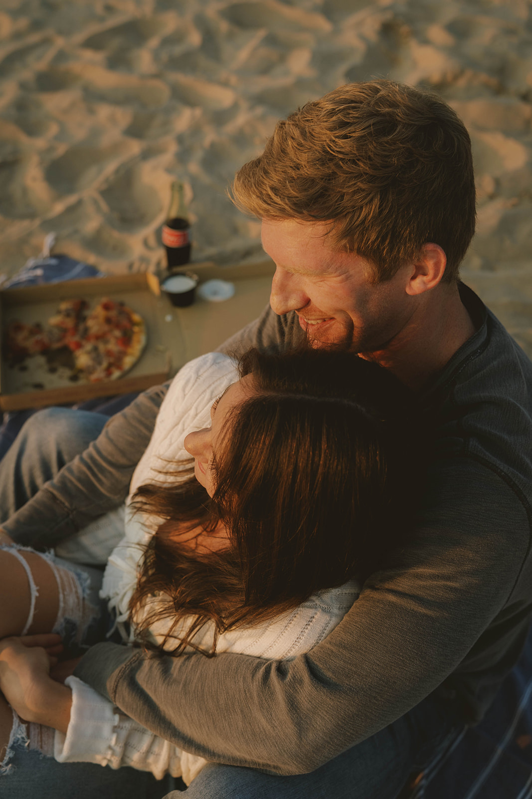 couple embrace and look out at the Lake Michigan waves