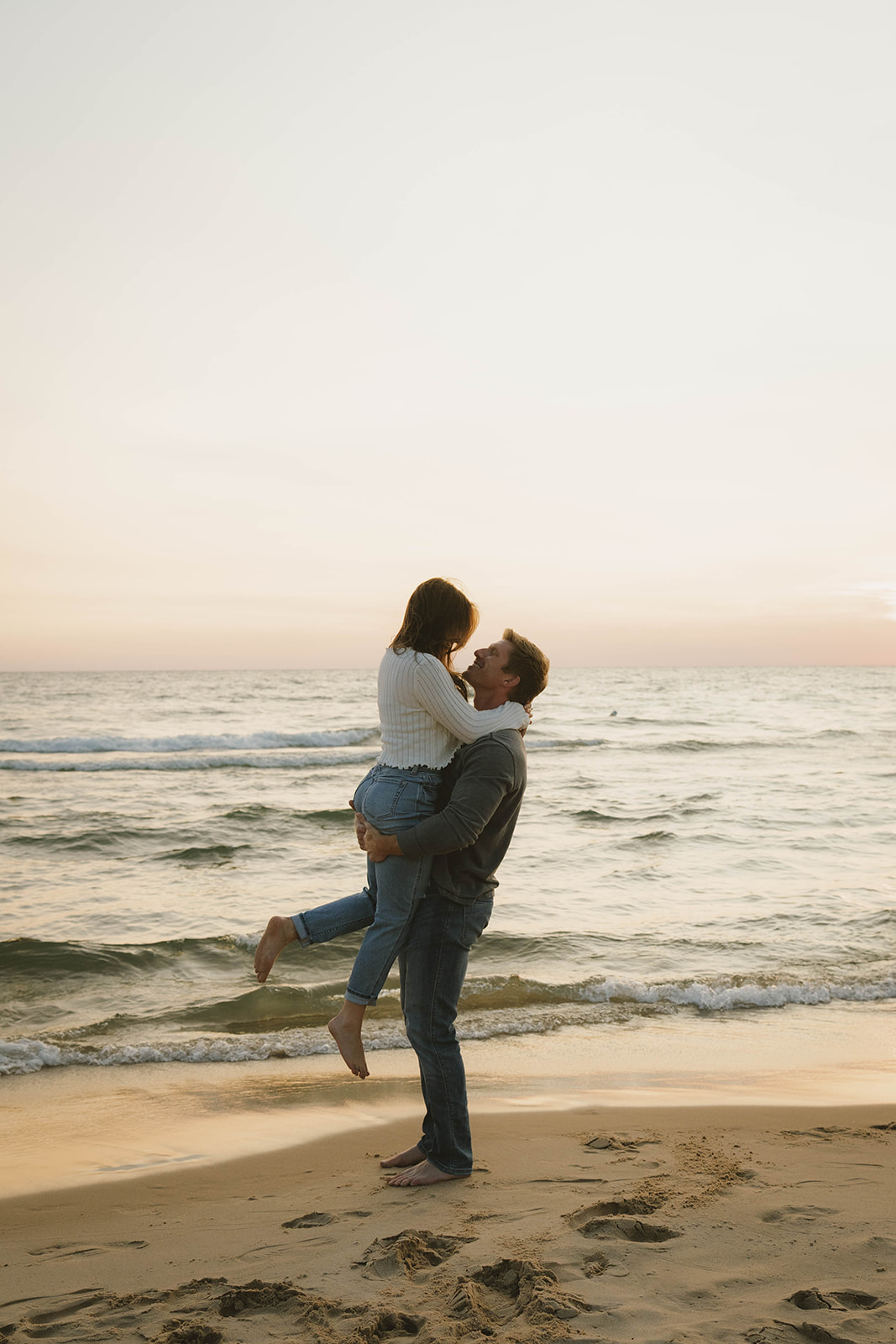 candid photo of a couple laughing, and enjoying their unique beach engagement session