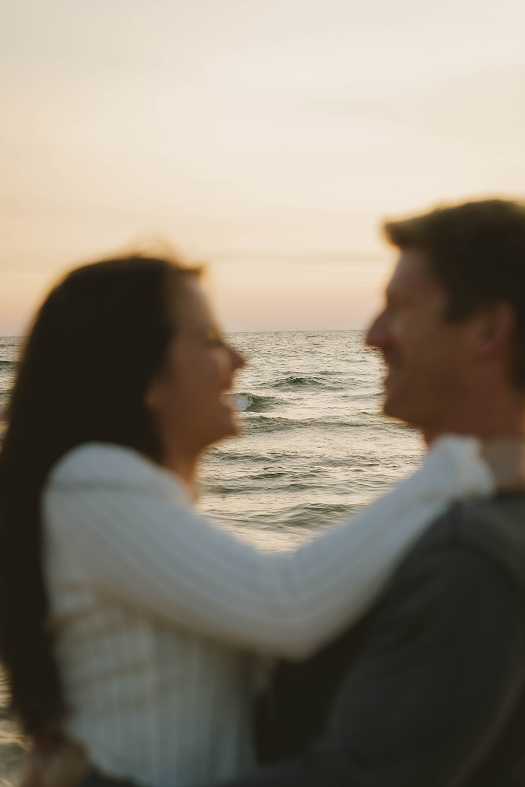 candid photo of a couple laughing, and enjoying their unique beach engagement session