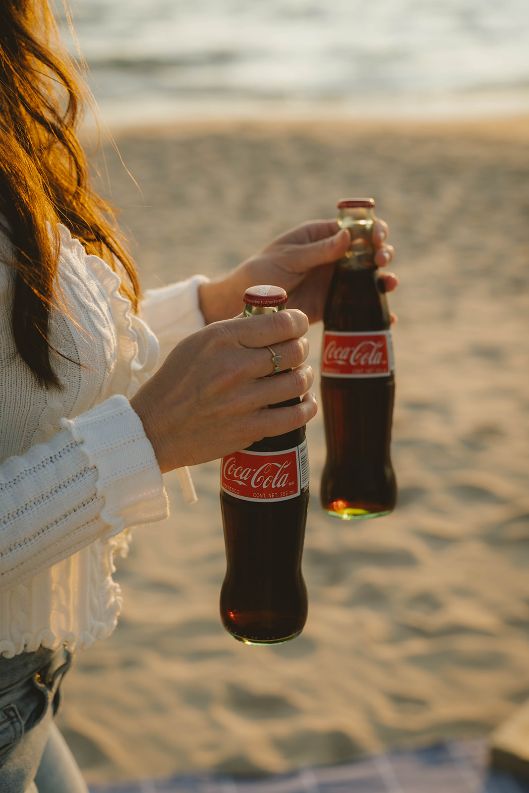 couple break out the classic coke bottles during their beach engagement photoshoot