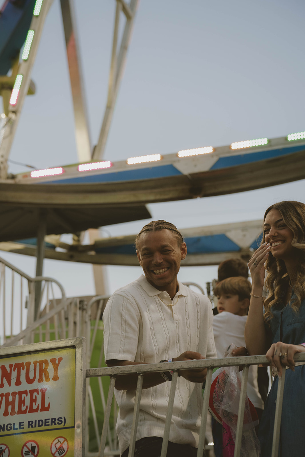 couple share laughter as they enjoy their fun couples photos at the state fair