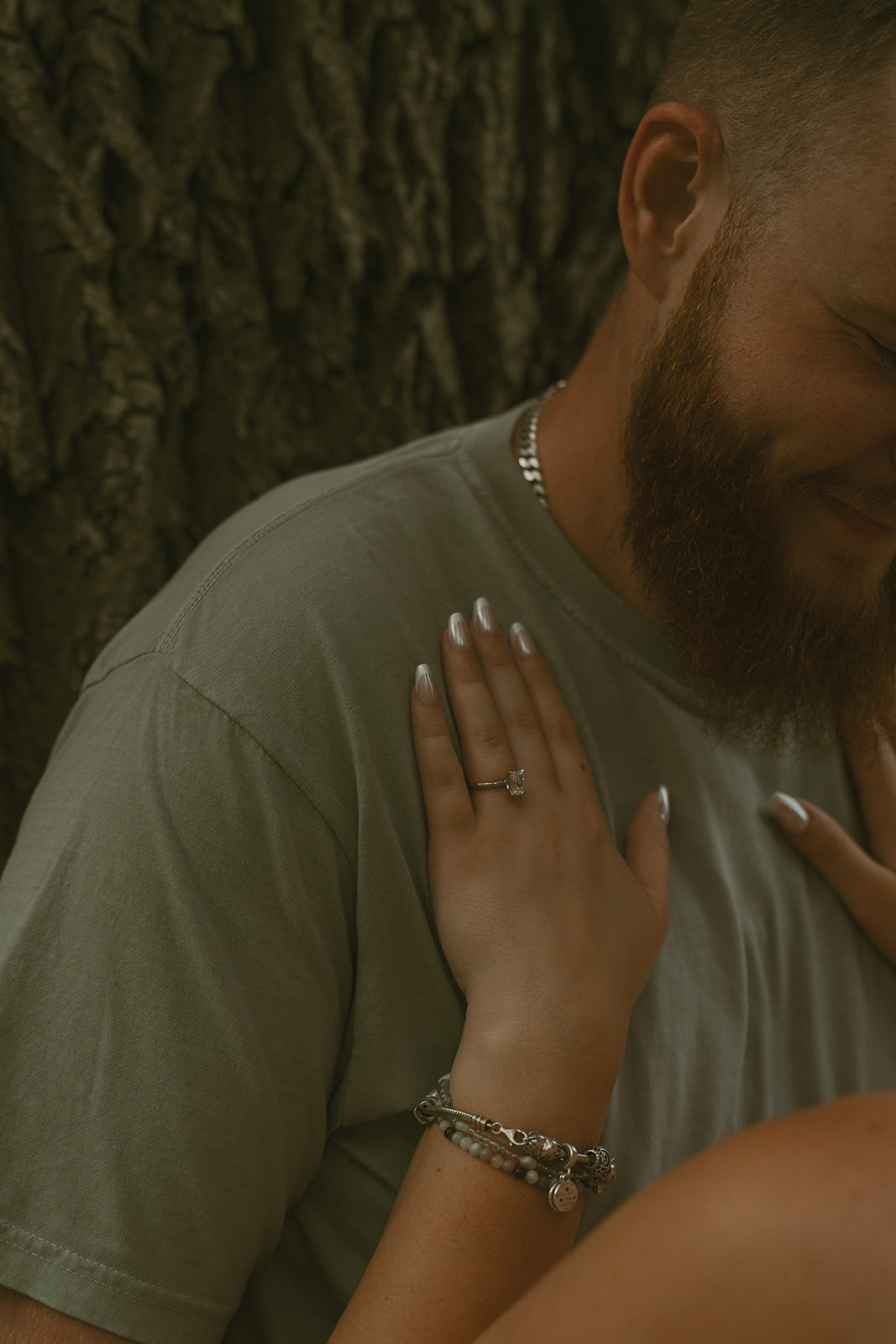 future wife holds her hand on her mans chest